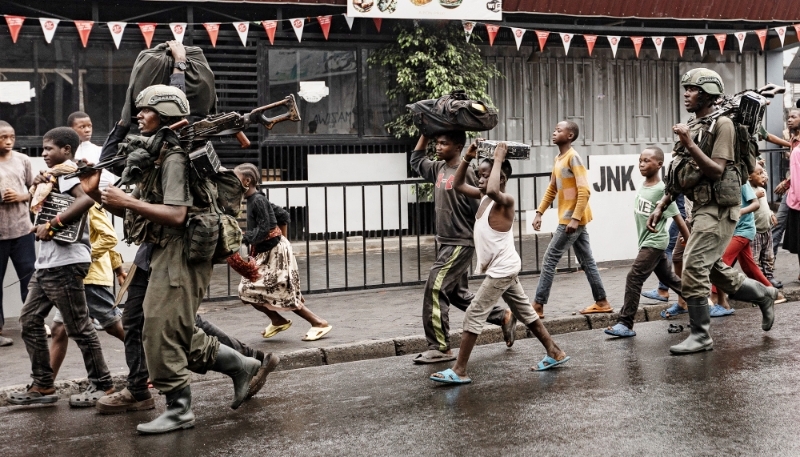 Members of the M23 armed group walk through a street in Goma, DR Congo, 27 January 2025.