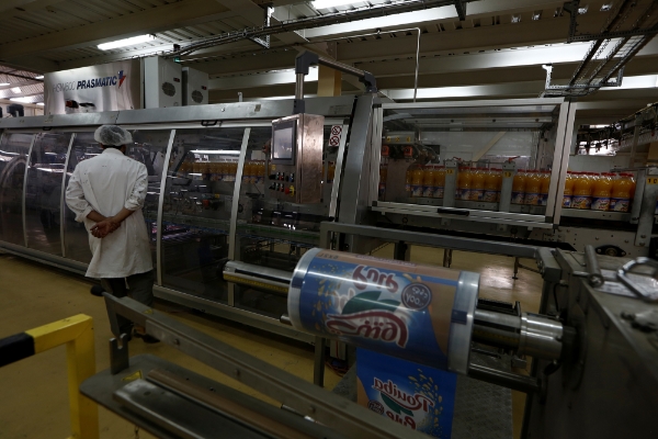 An employee monitors production at the Rouiba drinks factory on the outskirts of Algiers.